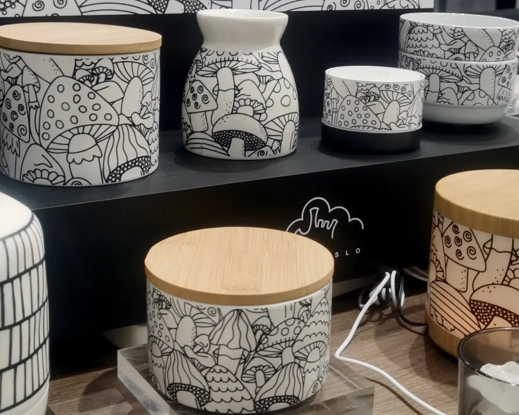 Green-Life aroma ware designs for home fragrance brands, featuring all-over black-and-white mushroom linework and natural wood-tone accents.